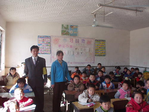 Yaojiayuan Zhongxin School education director Ma Ruigang (man, standing) with a language class.jpg